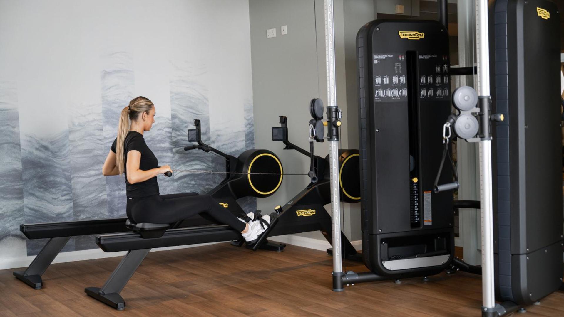 The Culloden Estate And Spa Holywood  Kültér fotó A woman using a rowing machine