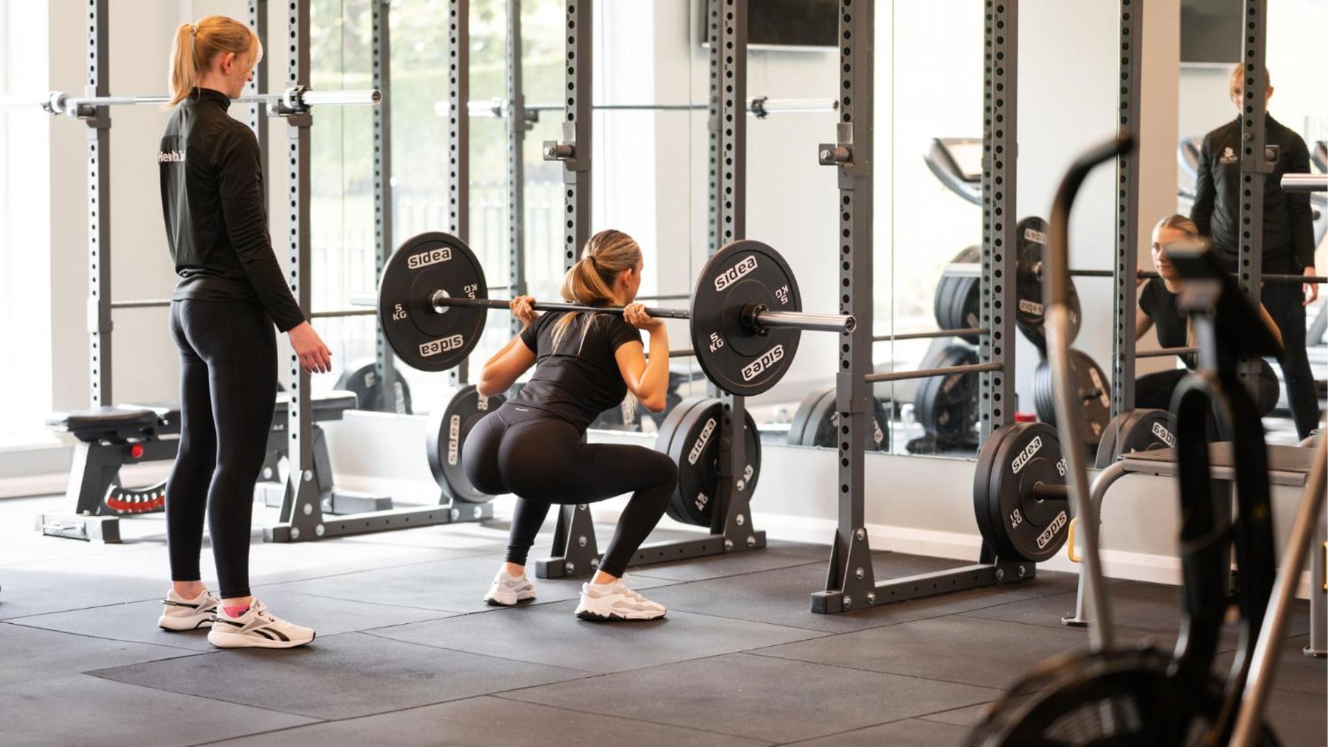 The Culloden Estate And Spa Holywood  Kültér fotó A woman performing a back squat with a barbell
